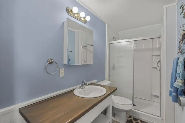 a bathroom with a sink toilet and shower
