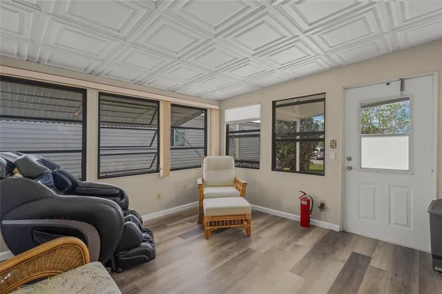 a living room with furniture and a glass door