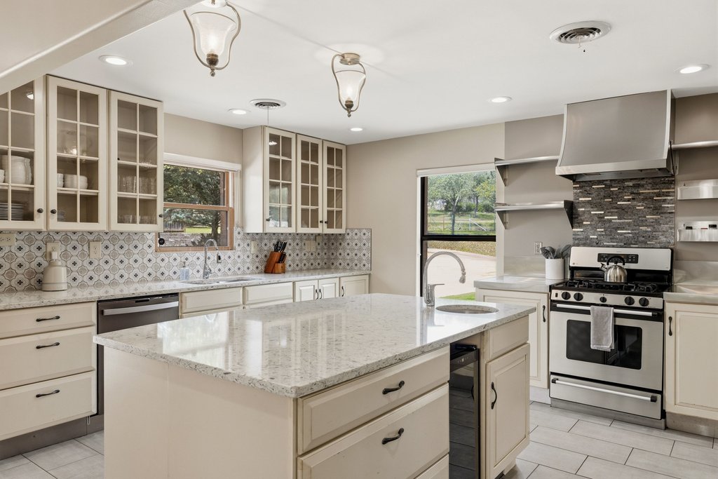 12135 Fitzhugh Road Austin, TX 78736 - Photo 3 of 30 a kitchen with granite countertop a sink stainless steel appliances and cabinets