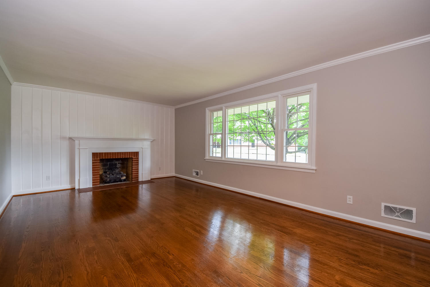 3075 Sedgefield Road Southwest Roanoke, VA 24018 - Photo 5 of 30 an empty room with wooden floor fireplace and windows