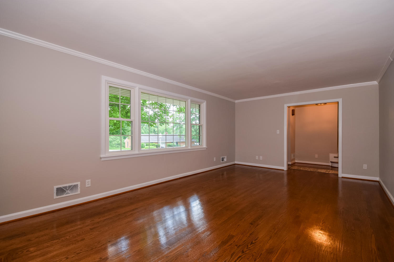 3075 Sedgefield Road Southwest Roanoke, VA 24018 - Photo 6 of 30 a view of an empty room with wooden floor and a window