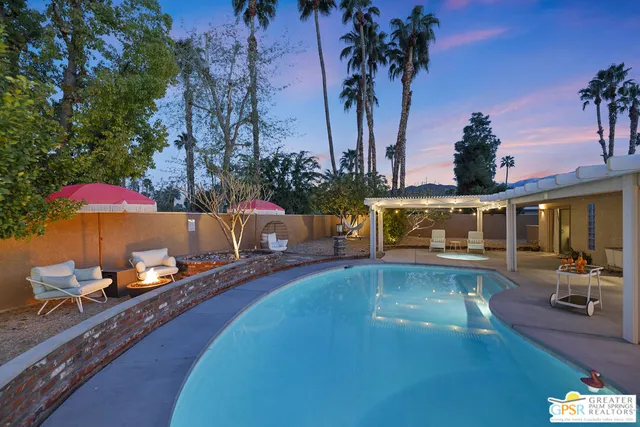 a swimming pool with outdoor seating