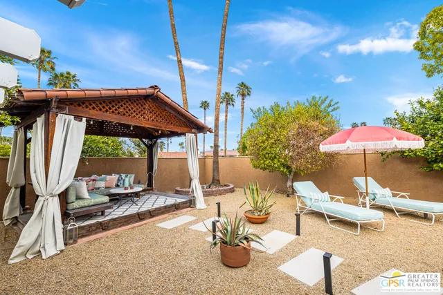 a view of a house with a backyard and a patio