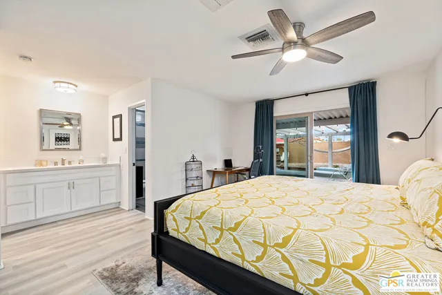 a bedroom with a large bed and a chandelier