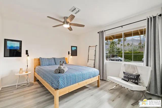 a bedroom with a bed a couch and a window