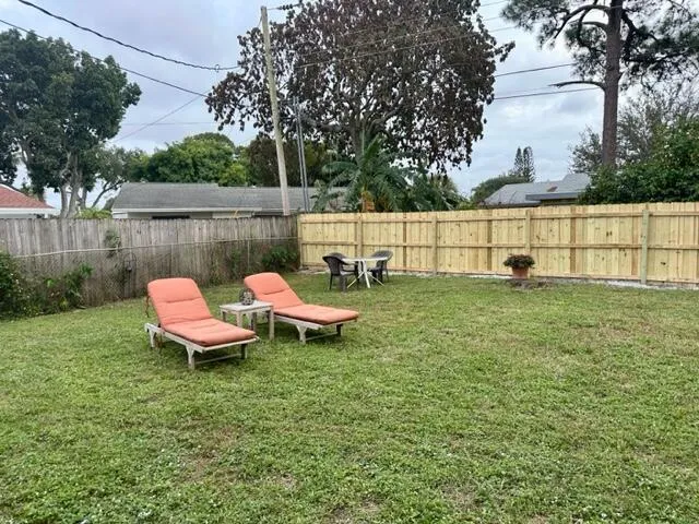 a view of a bench in backyard of the house