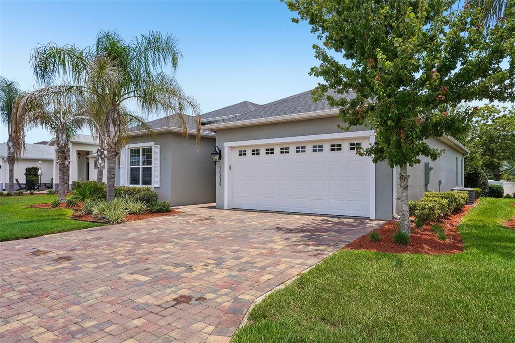 10339 Addison Shore Way Oxford, FL 34484 - Photo 22 of 54 a front view of a house with a yard and a garage