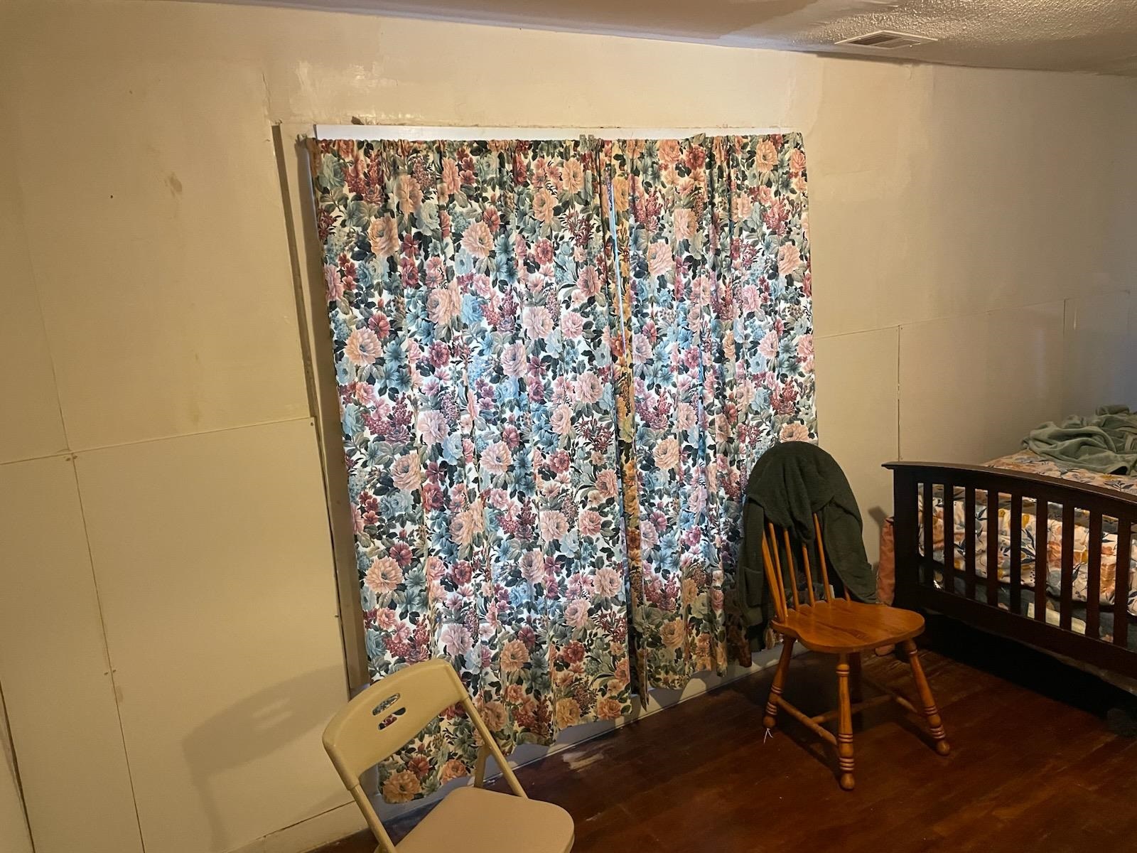 3533 Kendrick Road Memphis, TN 38108 - Photo 4 of 13 Bedroom with dark wood-type flooring and a nursery area