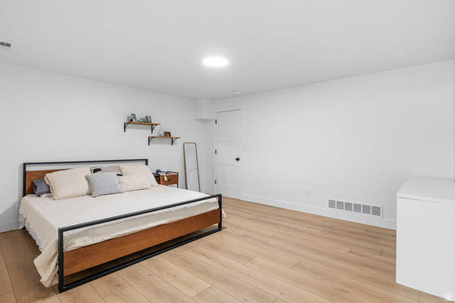 4150 Dover Lane Provo, UT 84604 - Photo 32 of 44 Spacious room featuring light wood-finish flooring, white walls, and a recessed ceiling light