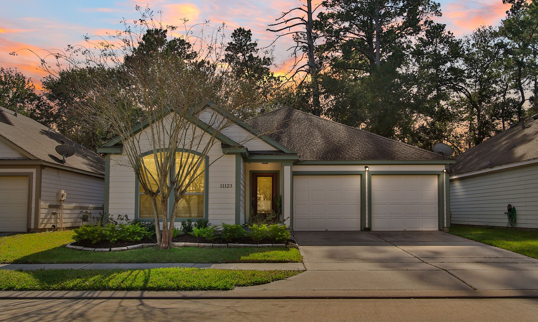 11123 Pembroke Ridge Drive Houston, TX 77065 - Photo 1 of 43 a front view of a house with garden