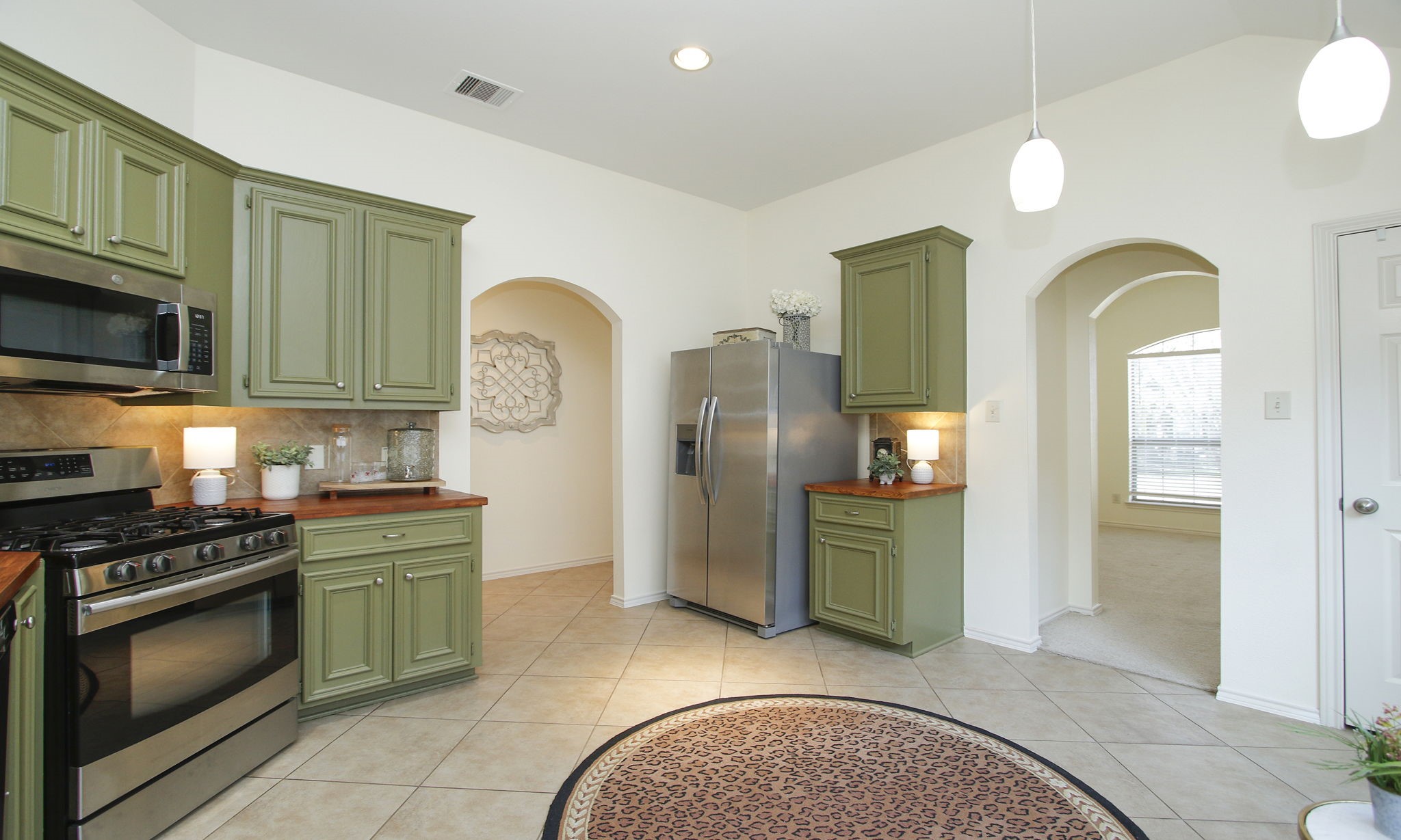 11123 Pembroke Ridge Drive Houston, TX 77065 - Photo 16 of 43 a kitchen with stainless steel appliances granite countertop a stove a sink and a microwave