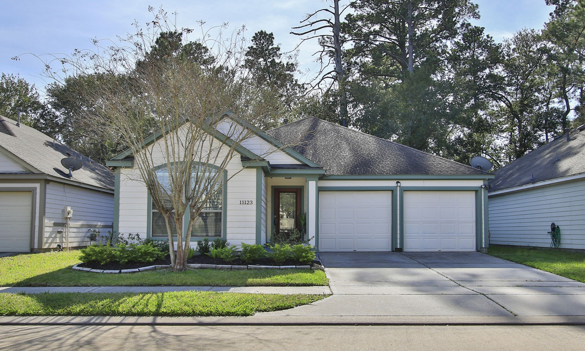 11123 Pembroke Ridge Drive Houston, TX 77065 - Photo 2 of 43 a front view of a house with a yard and garage