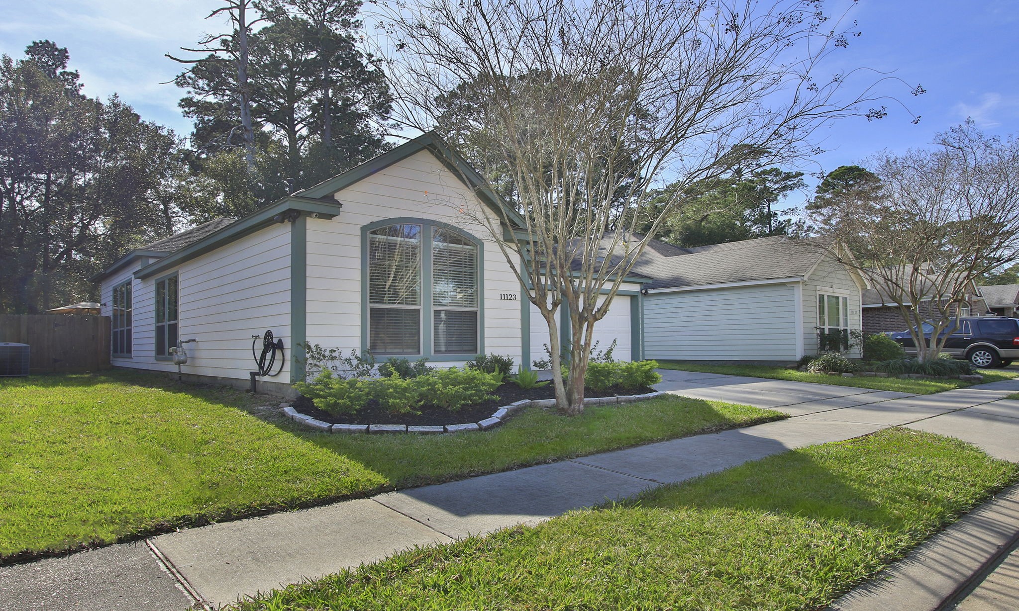 11123 Pembroke Ridge Drive Houston, TX 77065 - Photo 3 of 43 a front view of a house with garden