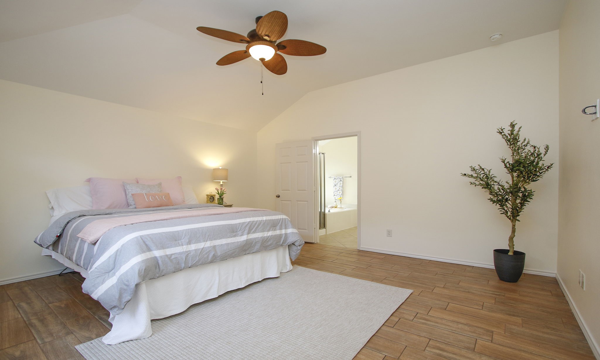 11123 Pembroke Ridge Drive Houston, TX 77065 - Photo 32 of 43 a spacious bedroom with a bed and a potted plant