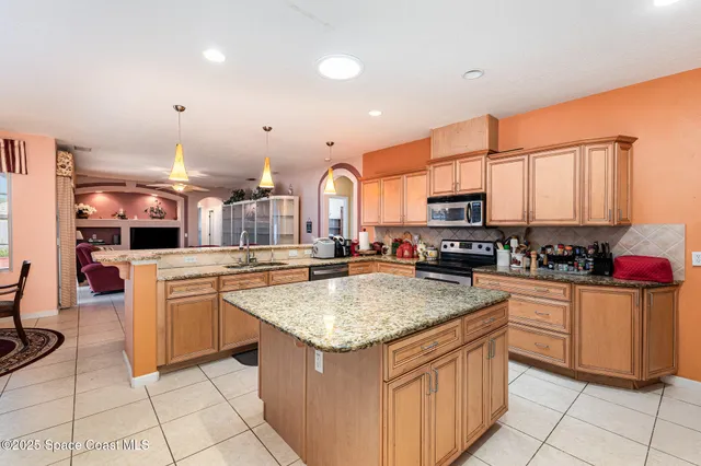 a kitchen with stainless steel appliances granite countertop a sink and cabinets