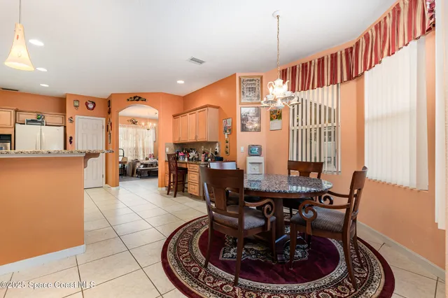 a dining room with furniture a window and kitchen view