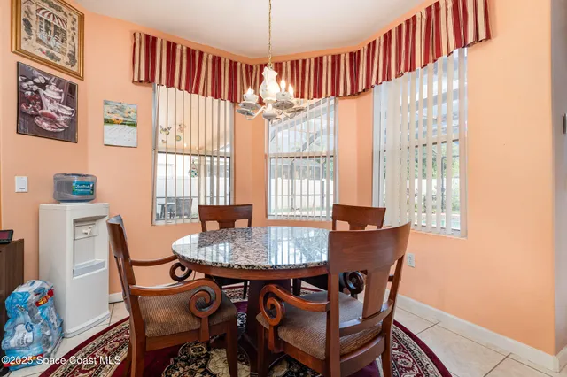 a dining room with furniture and window