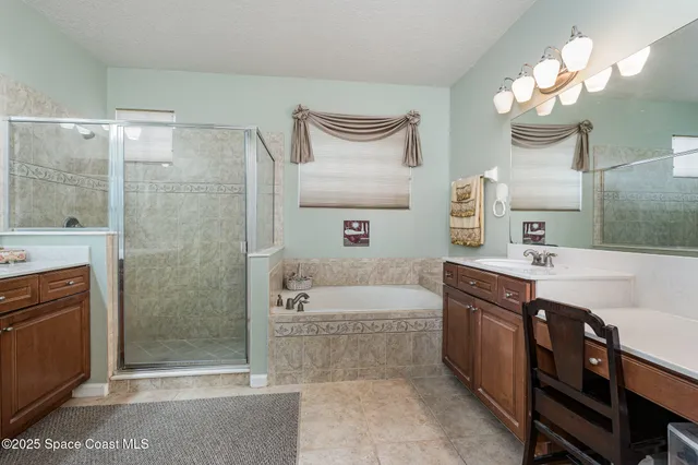 a bath room with a sink a vanity and a mirror