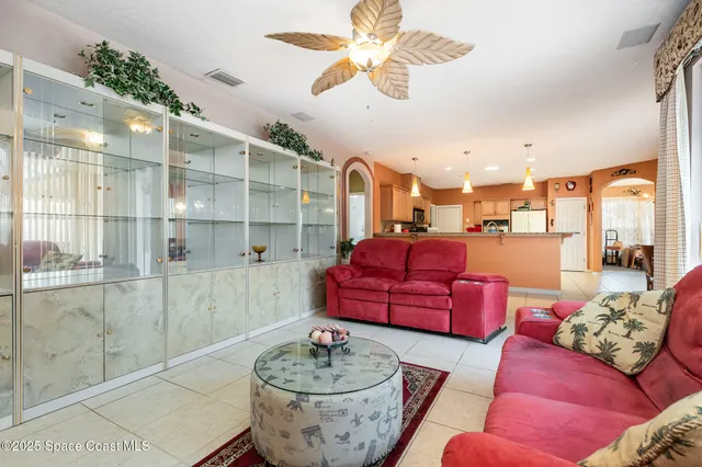 a living room with furniture and a potted plant