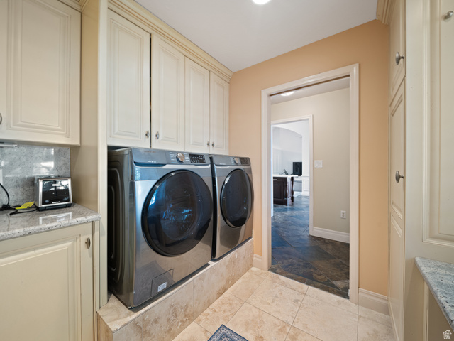 13357 Trail Rider Circle Draper, UT 84020 - Photo 48 of 70 Laundry area featuring extensive built-in cabinetry, tiled flooring, countertop space, and a stone backsplash