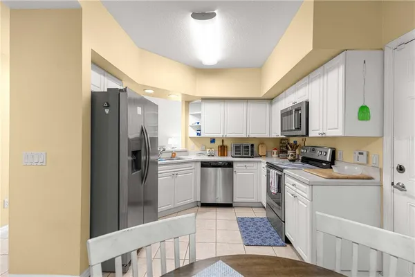 a kitchen with a sink stainless steel appliances and cabinets