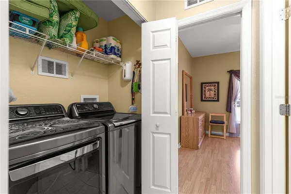 a kitchen with a stove and a wooden floor