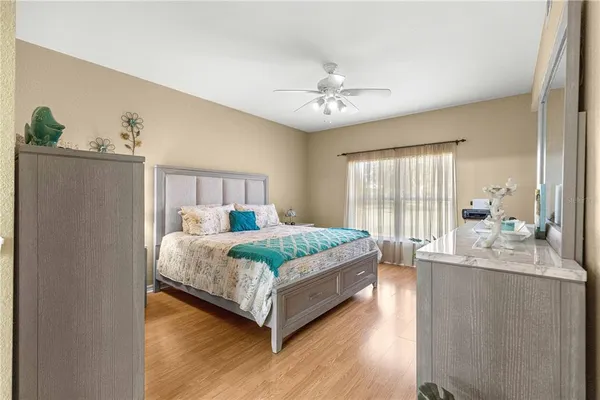 a bedroom with a large bed and a chandelier