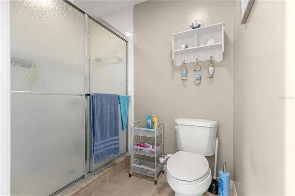 a white toilet sitting next to a bathroom sink and a mirror