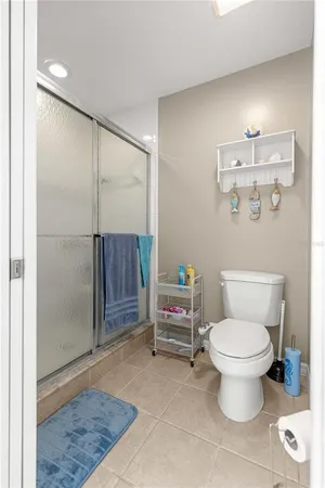 a bathroom with a toilet and a shower