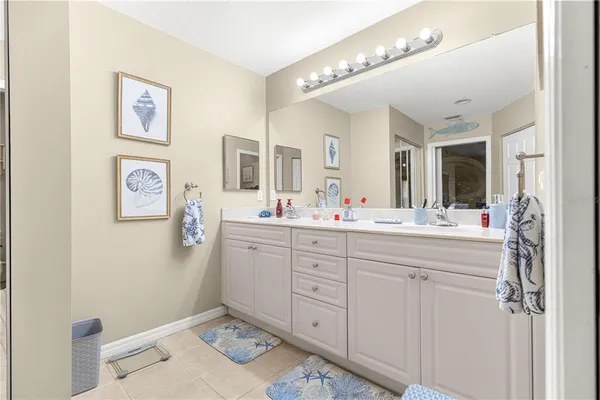 a bathroom with a double vanity sink mirror and