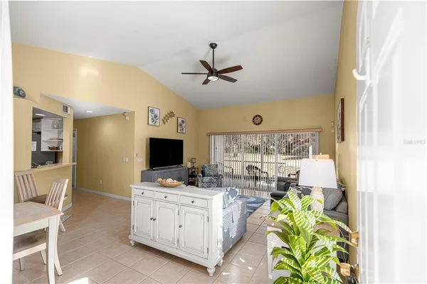 a kitchen with a stove a refrigerator and a dining table