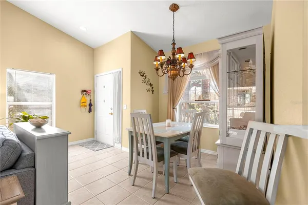 a dining room with furniture a chandelier and a rug