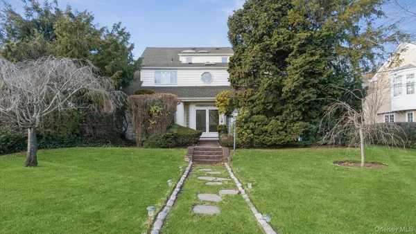 a front view of a house with a garden