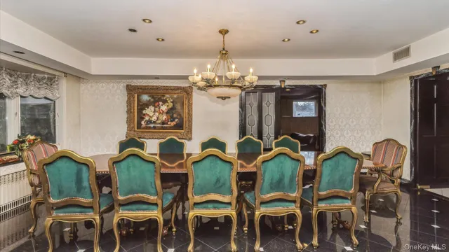 a view of a dining room with furniture and chandelier