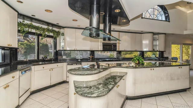 a kitchen with stainless steel appliances granite countertop a sink and a stove