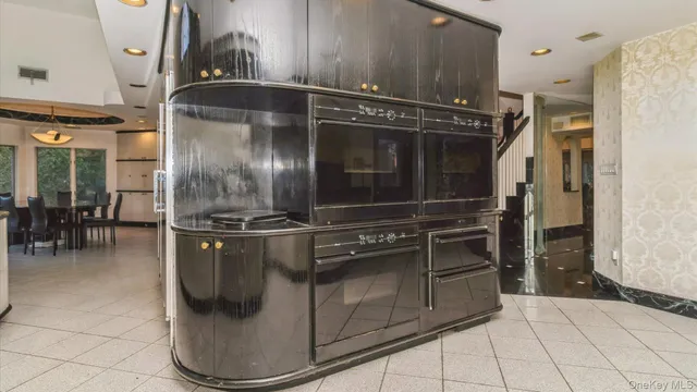 a kitchen with granite countertop a refrigerator and a stove