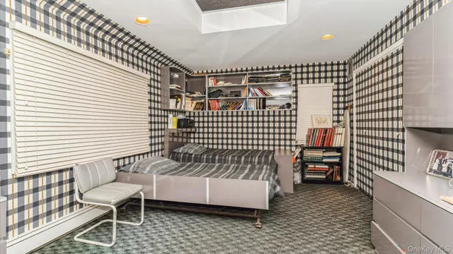 a bedroom with a bed dresser and a window