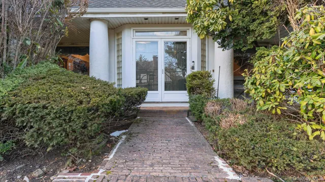 a view of a pathway of the house with potted plants