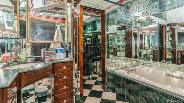 a bathroom with a granite countertop sink a toilet and mirror