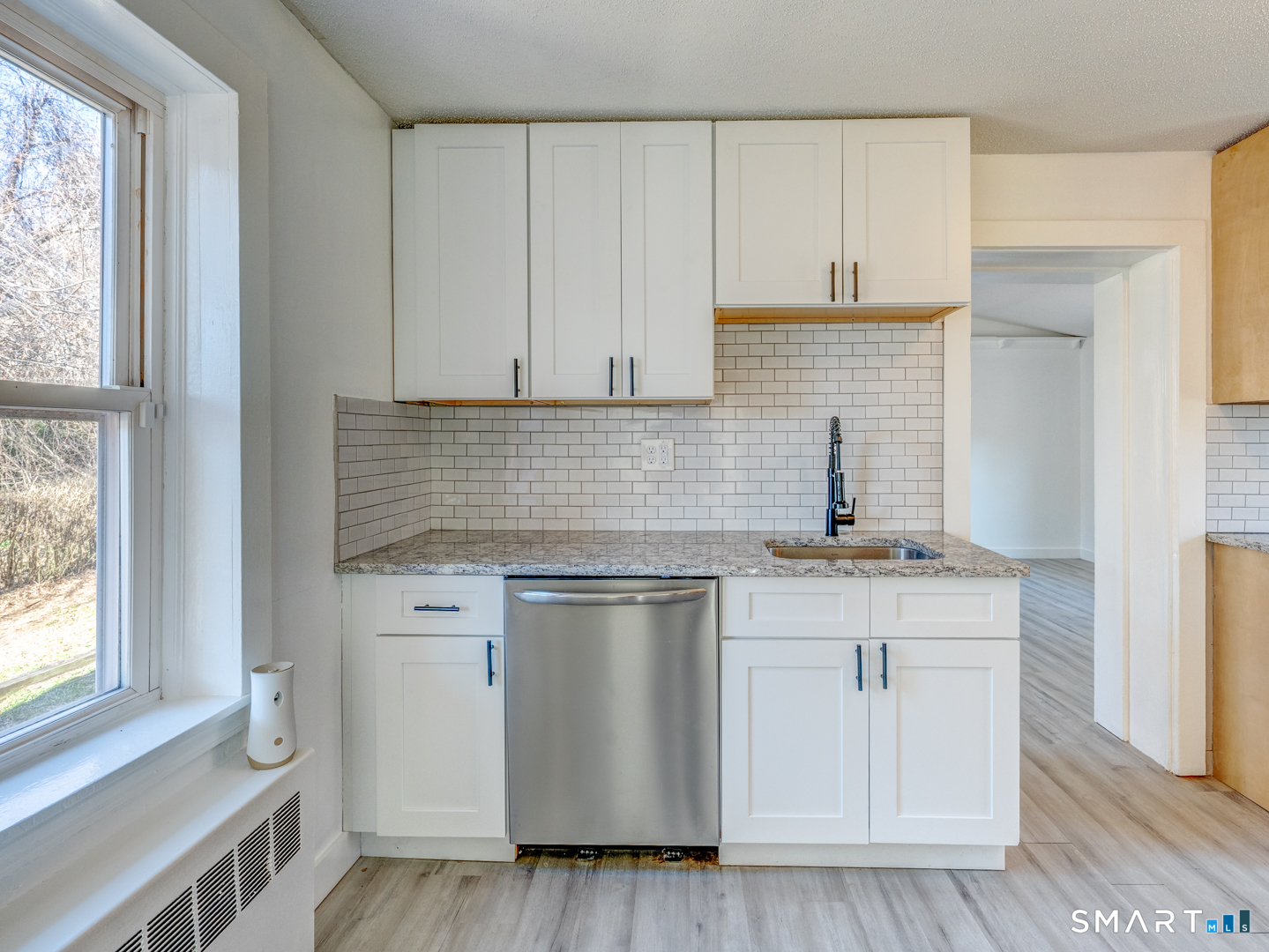 7 Rose Street Norwich, CT 06360 - Photo 15 of 37 a kitchen with stainless steel appliances white cabinets and a stove top oven