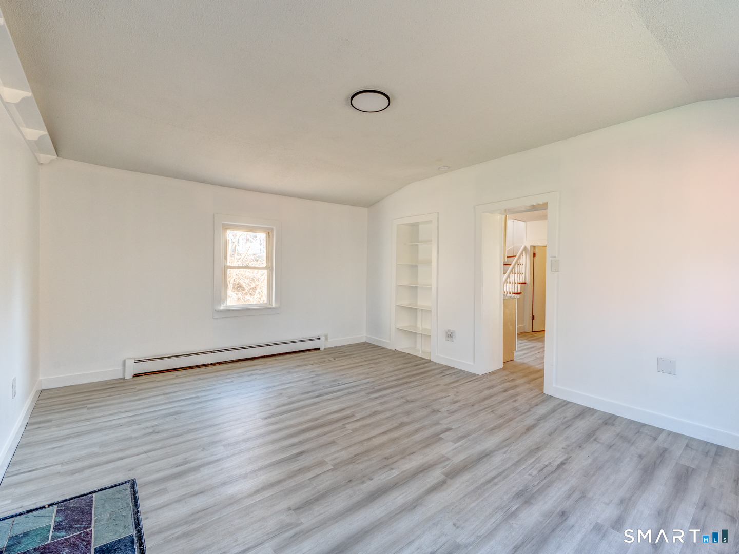 7 Rose Street Norwich, CT 06360 - Photo 21 of 37 an empty room with wooden floor and windows