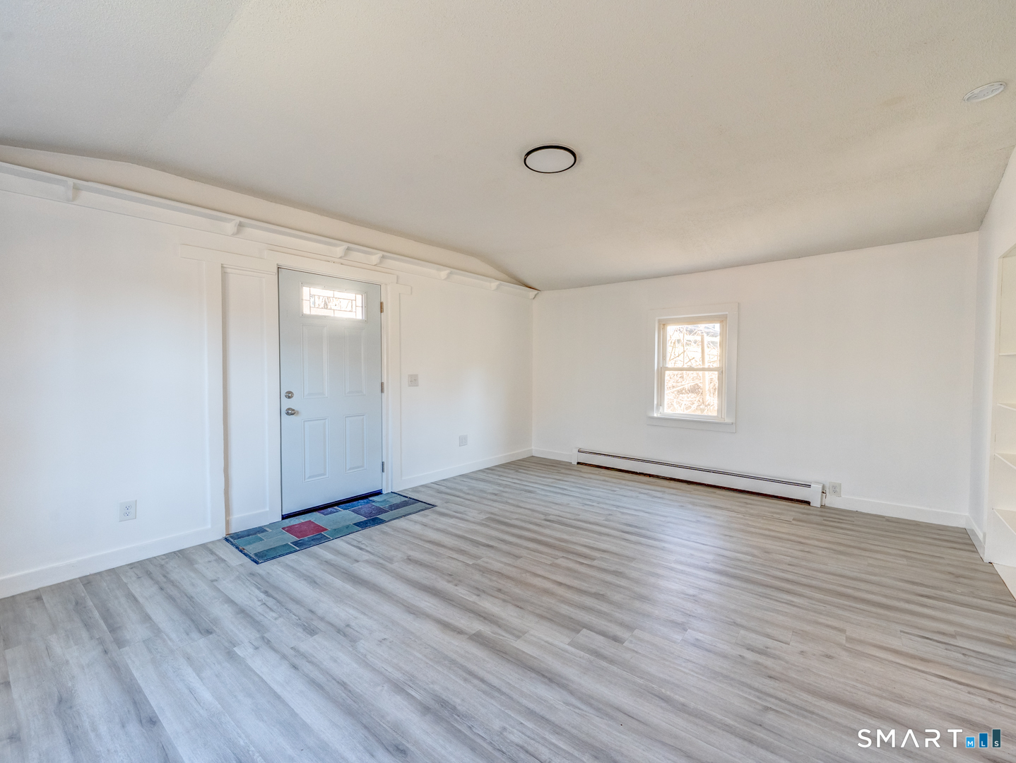 7 Rose Street Norwich, CT 06360 - Photo 22 of 37 an empty room with wooden floor and windows