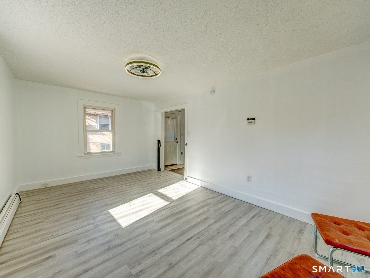 7 Rose Street Norwich, CT 06360 - Photo 26 of 37 an empty room with wooden floor and windows