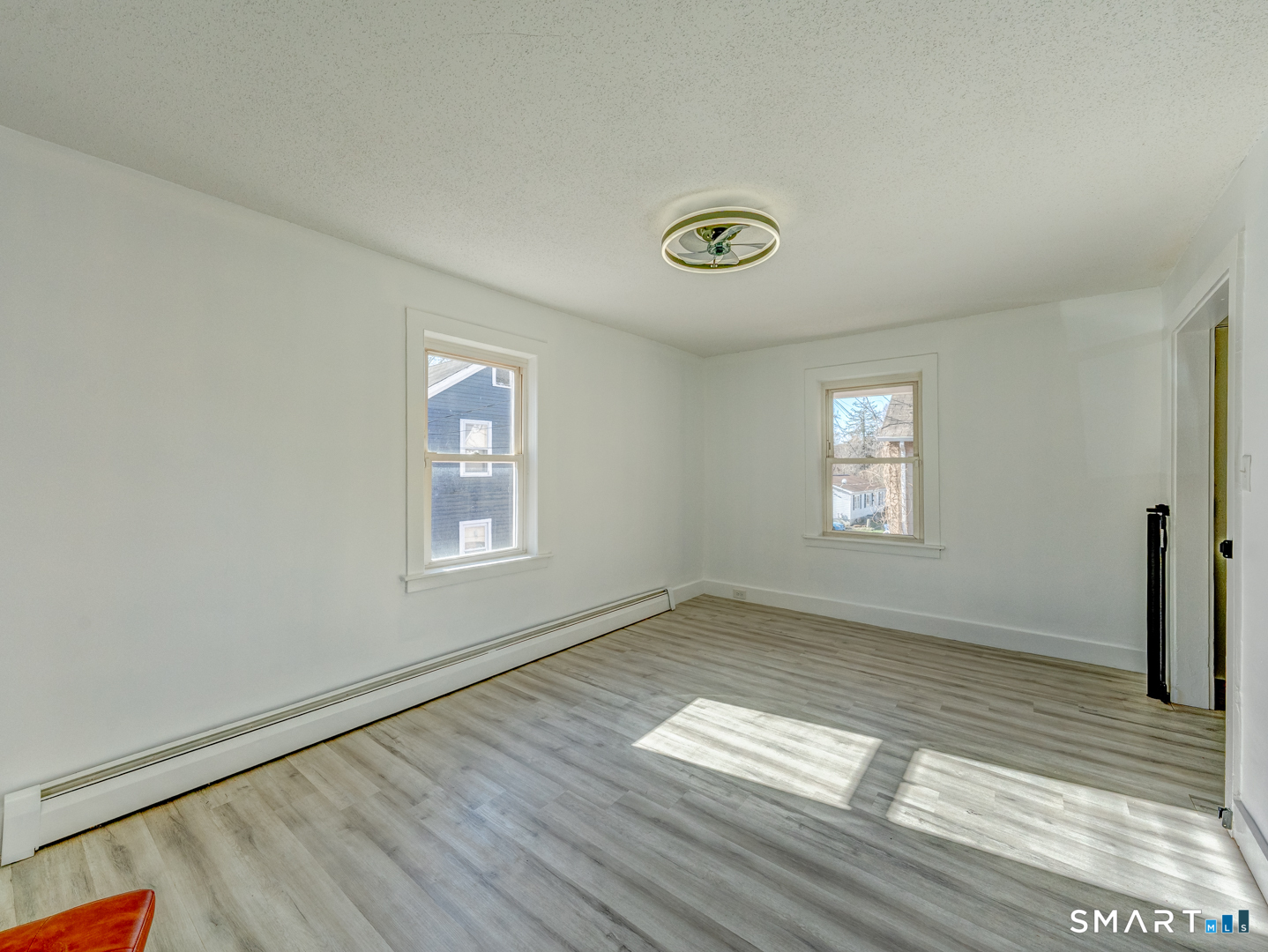 7 Rose Street Norwich, CT 06360 - Photo 27 of 37 an empty room with wooden floor and windows