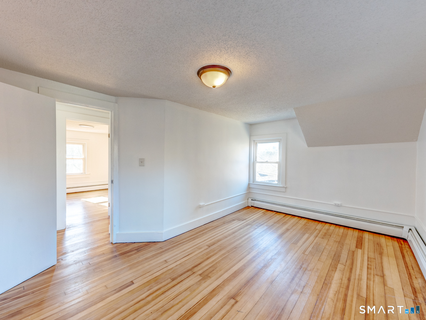 7 Rose Street Norwich, CT 06360 - Photo 29 of 37 a view of empty room with wooden floor and fan