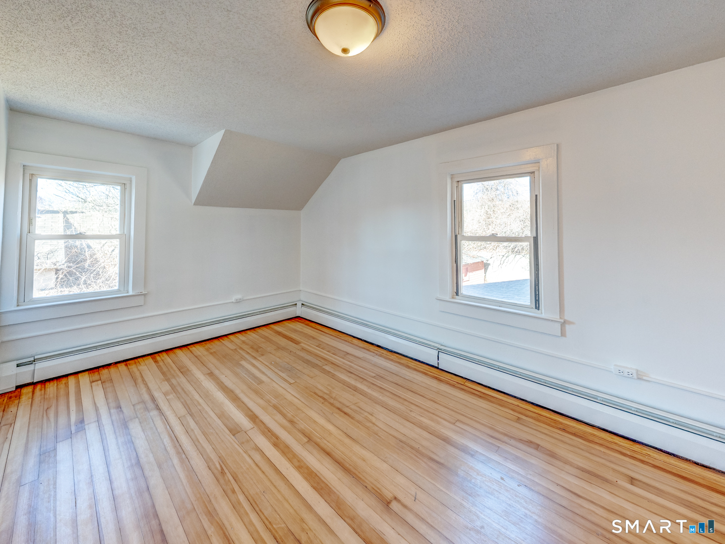 7 Rose Street Norwich, CT 06360 - Photo 30 of 37 an empty room with wooden floor and windows