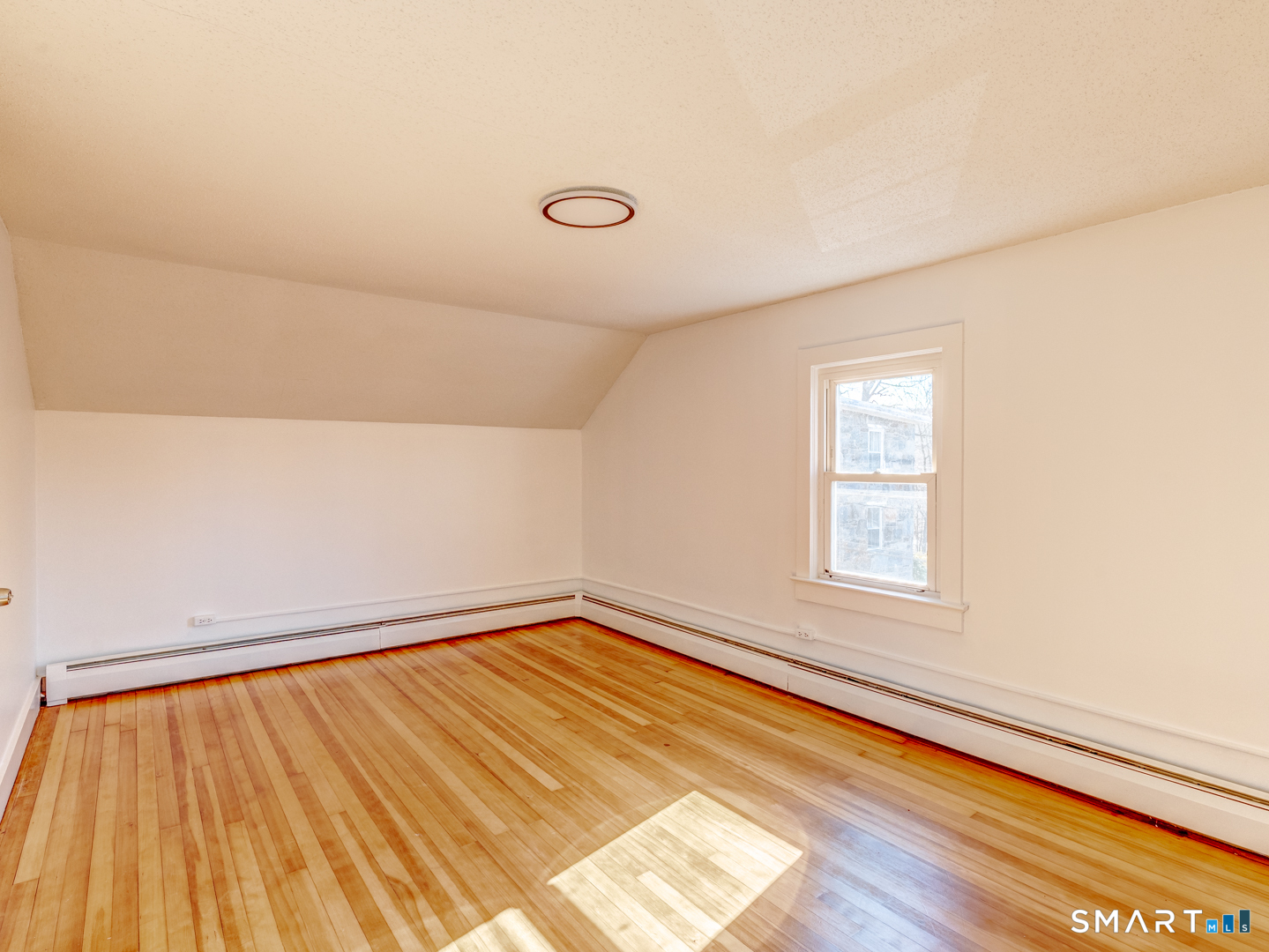 7 Rose Street Norwich, CT 06360 - Photo 33 of 37 a view of an empty room with wooden floor and a window