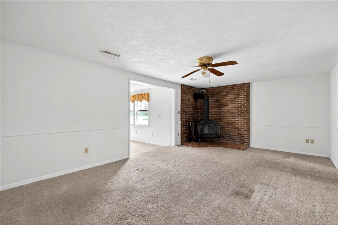 7988 McCool Road Greenville, OH 45331 - Photo 10 of 50 This inviting living area features a charming fireplace, perfect for cozy gatherings.