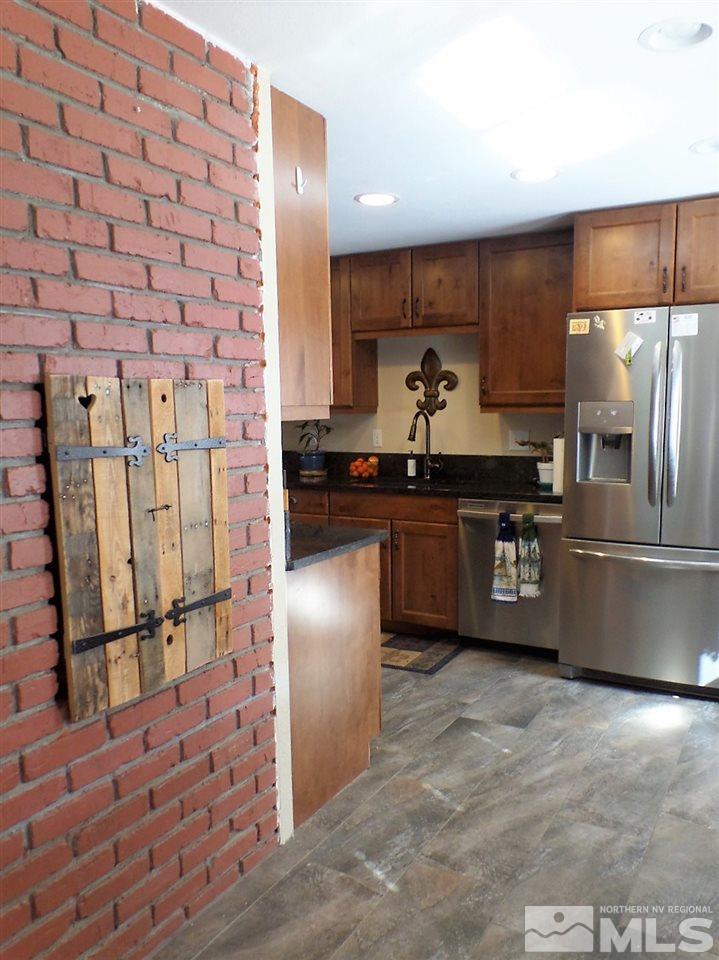 2590 Trentham Way Reno, NV 89509 - Photo 15 of 25 a kitchen with stainless steel appliances granite countertop a refrigerator a sink a stove and a refrigerator