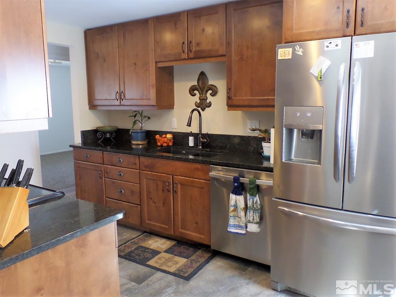 2590 Trentham Way Reno, NV 89509 - Photo 16 of 25 a kitchen with stainless steel appliances granite countertop a refrigerator and a stove